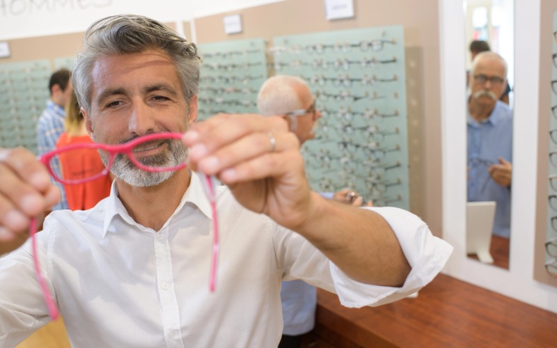 handsome ophthalmologist holding eyeglasses